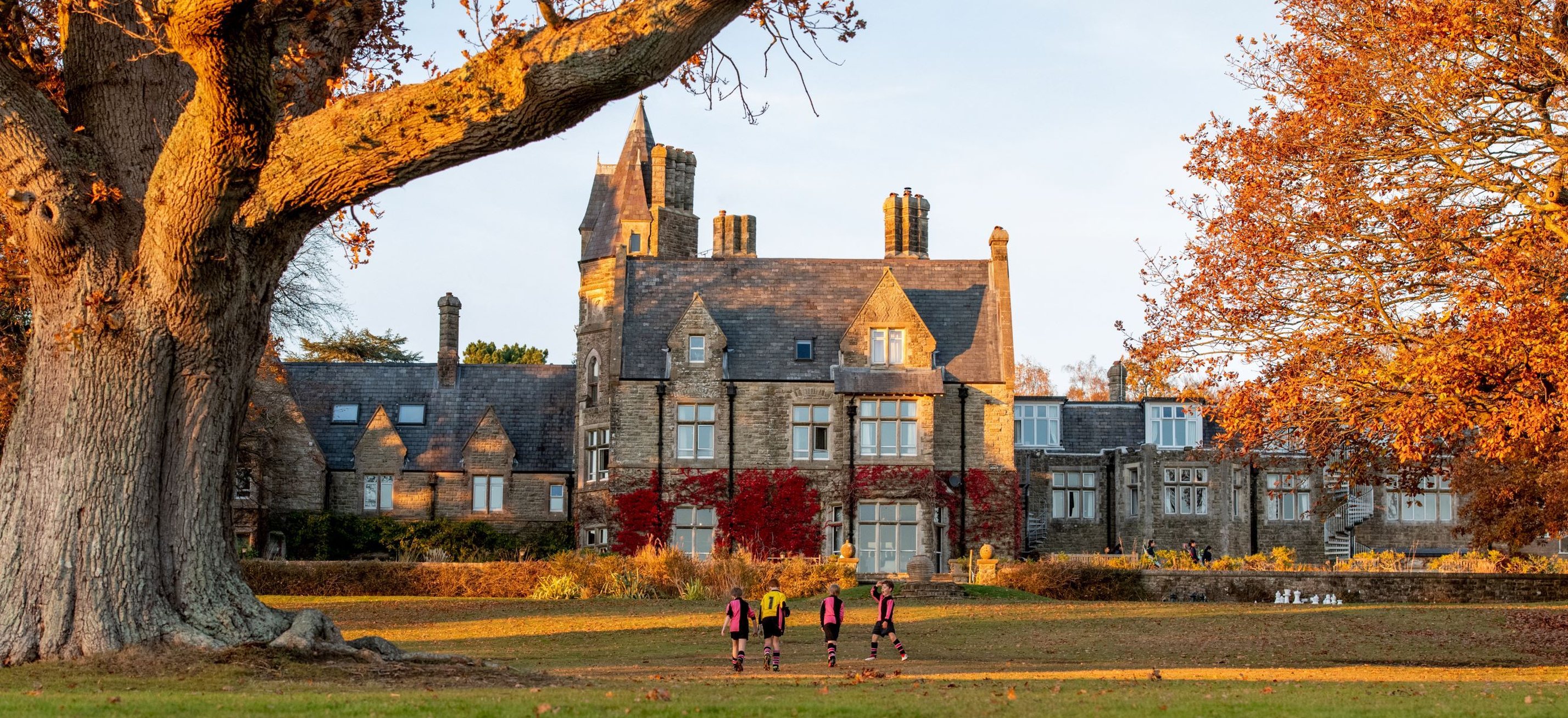 Brambletye School's main building in autumn, across the playing fields