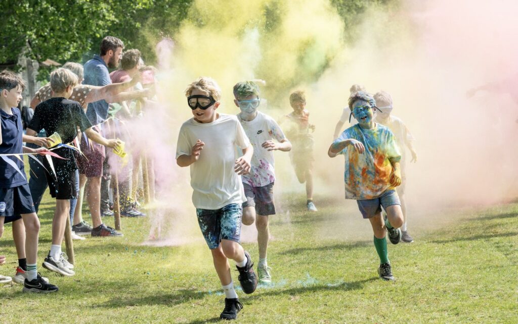 Brambletye pupils running through coloured powder on the playing field